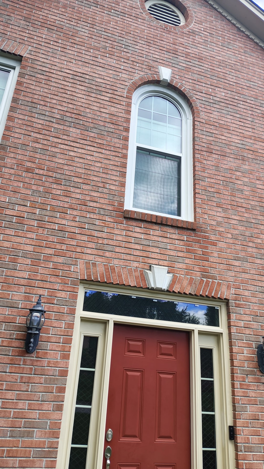 Arched window & entry door on brick
